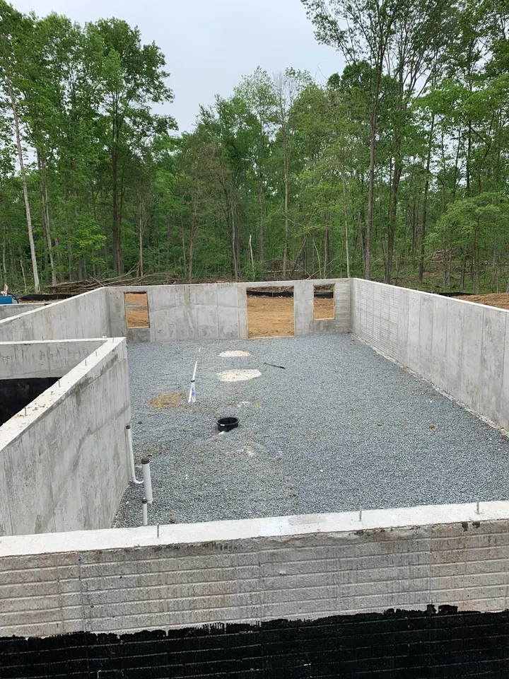 Concrete foundation walls and stone base during the Spotsylvania house build