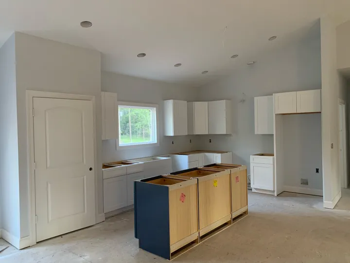 Kitchen cabinets and island being installed before countertops in the Spotsylvania house