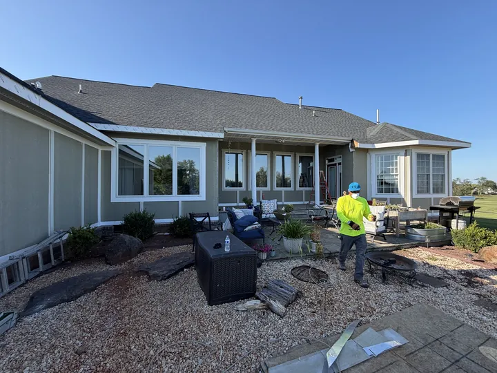 Siding and window trim beside the patio during installation